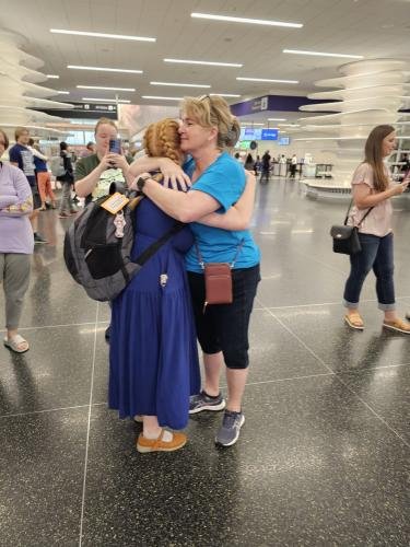 Alyssa gives mom a big hug before boarding the airplane for her mission