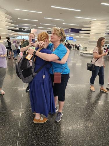 Alyssa gives mom a big hug before boarding the airplane for her mission