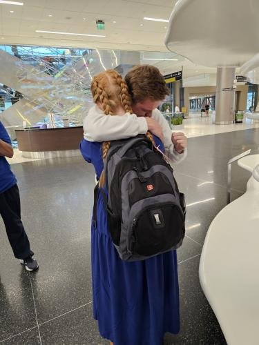 Alyssa hugs Elliot just before boarding her plane for her mission