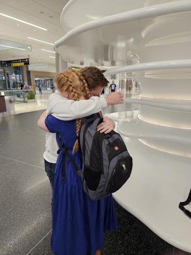 Alyssa hugs Elliot just before boarding her plane for her mission