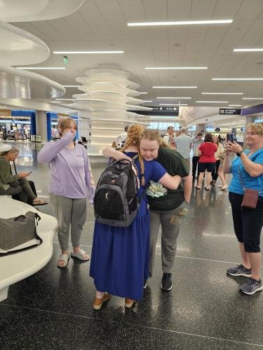 Alyssa hugs Lauren goodbye before she boards the plane for her mission