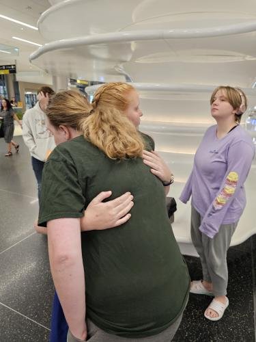 Alyssa hugs Lauren before boarding her plane for her mission