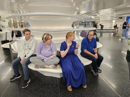 Elliot, Diana, Alyssa, and Clayton wait for Alyssa mission flight to depart