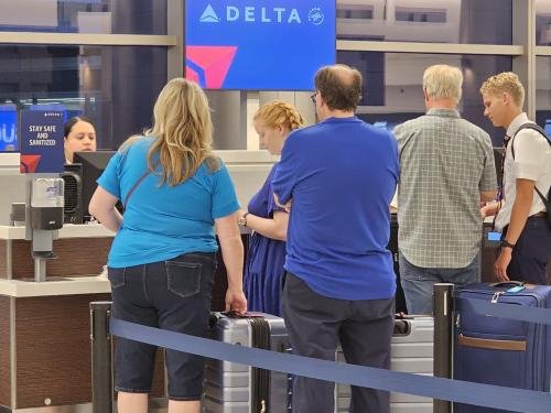 Amy, Clayton, and Alyssa waiting to check in to Alyssa's mission flight