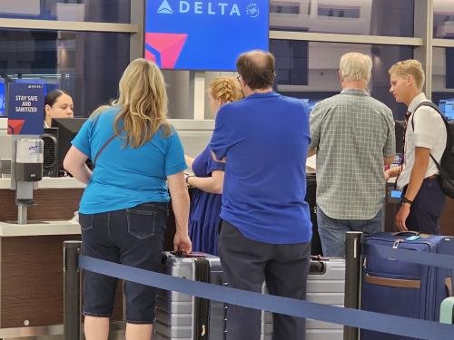 Amy, Clayton, and Alyssa waiting to check in to Alyssa's mission flight