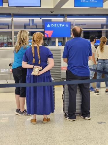 Amy, Clayton, and Alyssa waiting to check in to Alyssa's mission flight