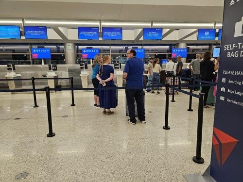 Amy, Clayton, and Alyssa waiting to check in to Alyssa's mission flight