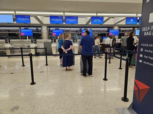 Amy, Clayton, and Alyssa waiting to check in to Alyssa's mission flight