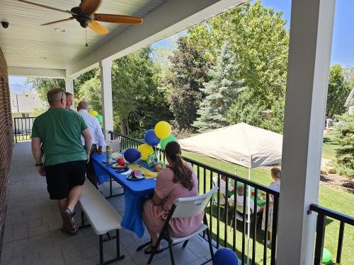 People mingle on the back porch during Alyssa's mission farewell open house