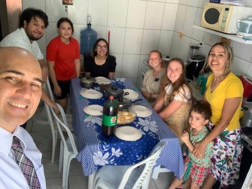 Alyssa and Sister Fuller eating with a member family