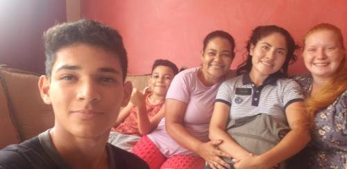 Alyssa and Sister Zurita with a member family