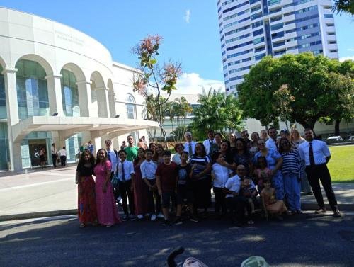 Alyssa and Sister Tadje with a large group of ward members at the temple