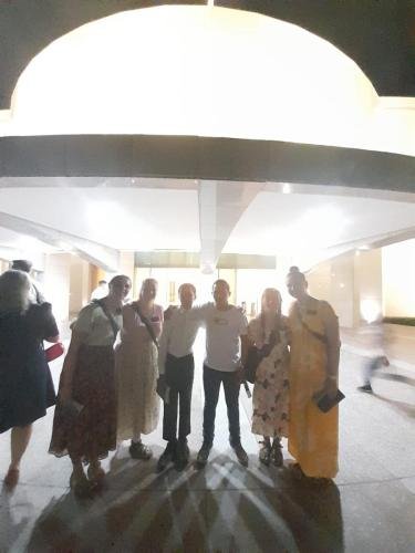 Alyssa and Sister Tadje with a group in front of the temple