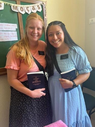Alyssa and Sister Villatoro with Books of Mormon in the church house