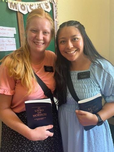 Alyssa and Sister Villatoro with Books of Mormon in the church house