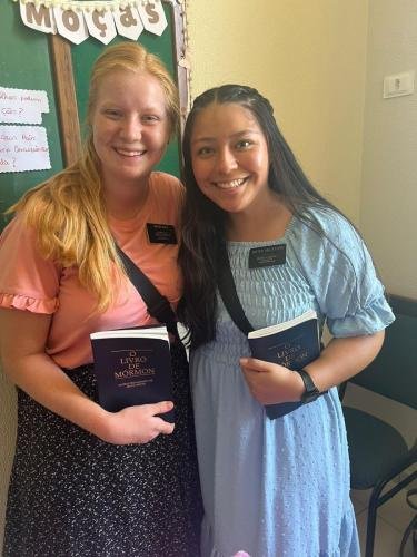Alyssa and Sister Villatoro with Books of Mormon in the church house