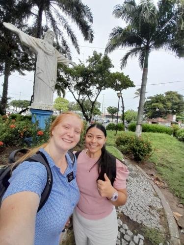 Alyssa and Sister Villatoro in front of a Christus statue in the park