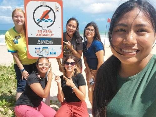 Alyssa with a large group of sisters by the beach