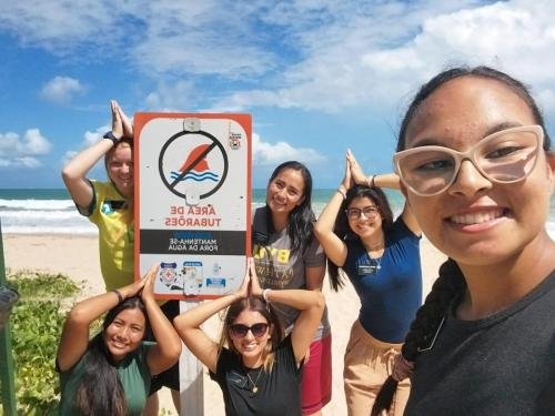 Alyssa with a large group of sisters by the beach