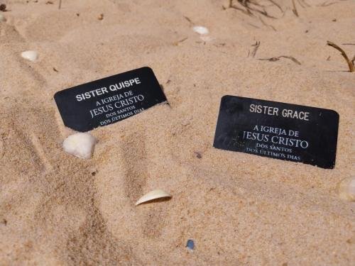 Alyssa's and Sister Quispe's name tags on the sand on the beach