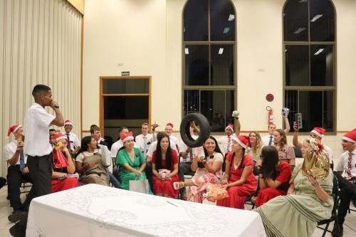 People getting their white elephant gifts at the 2023 mission Christmas party