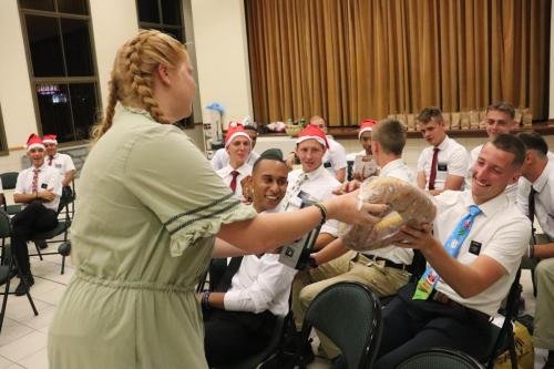 Alyssa swaps presents during the 2023 mission Christmas party