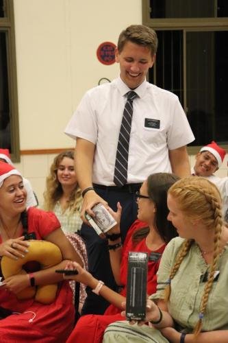 Alyssa watches as Sister Leopoldes exchanges gifts